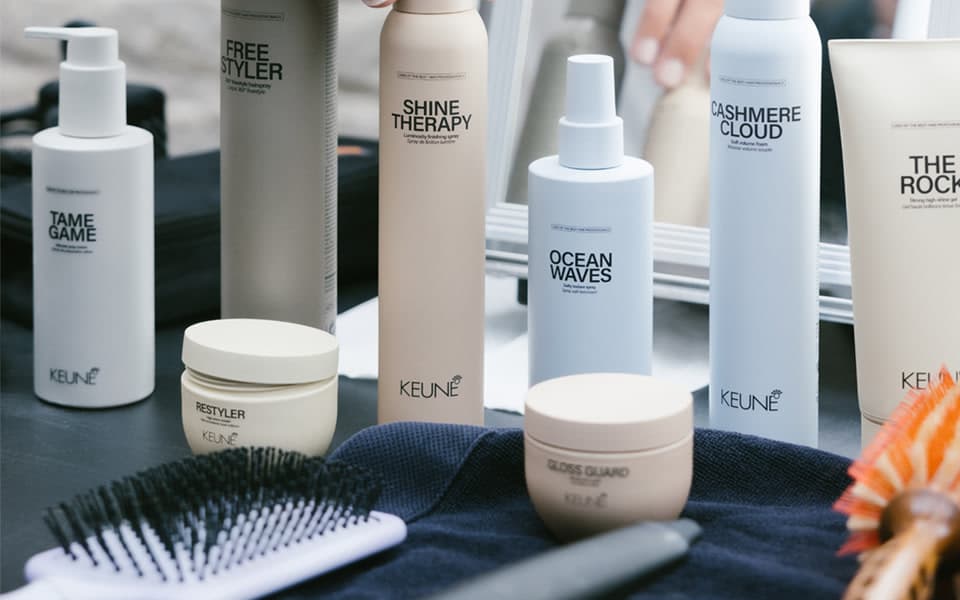A selection of KEUNE professional styling products in a salon setting