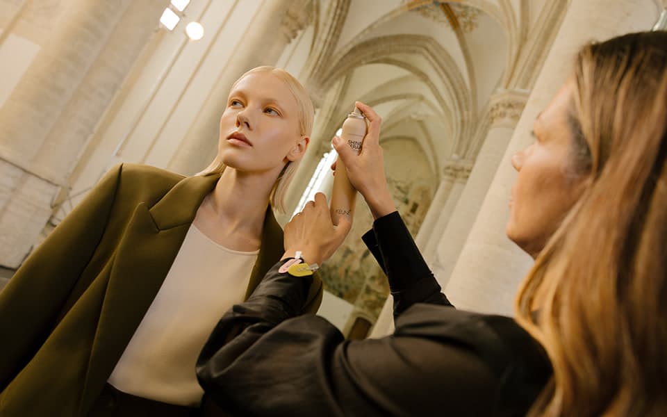 A KEUNE hair professional styling a model's blonde hair