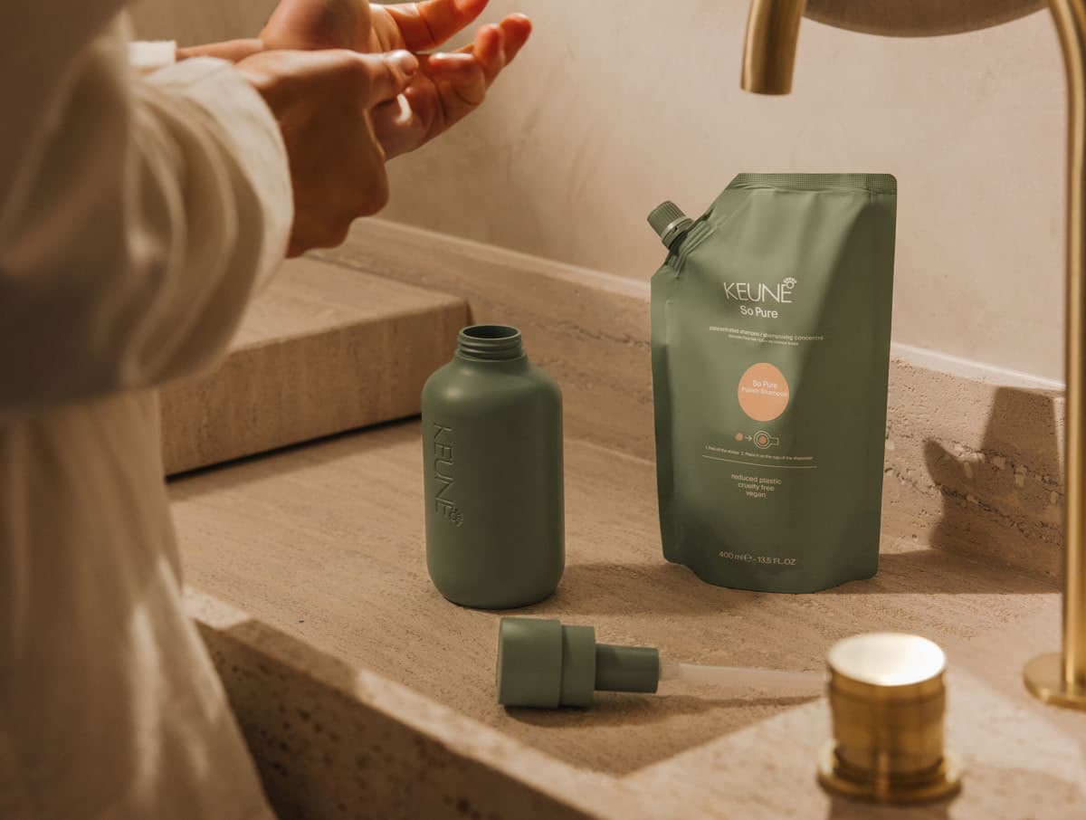 KEUNE So Pure refill bottle and pouch in a bathroom setting